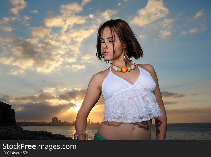 Portrait of young female fashion model posing against sunset sky. Portrait of young female fashion model posing against sunset sky