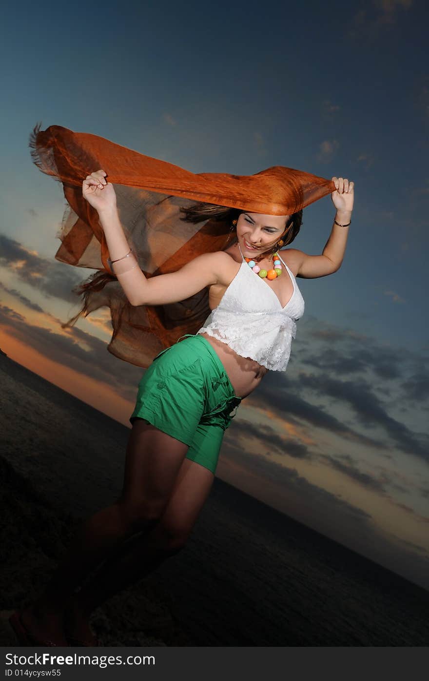 Portrait of young trendy female model posing against sunset sky. Portrait of young trendy female model posing against sunset sky