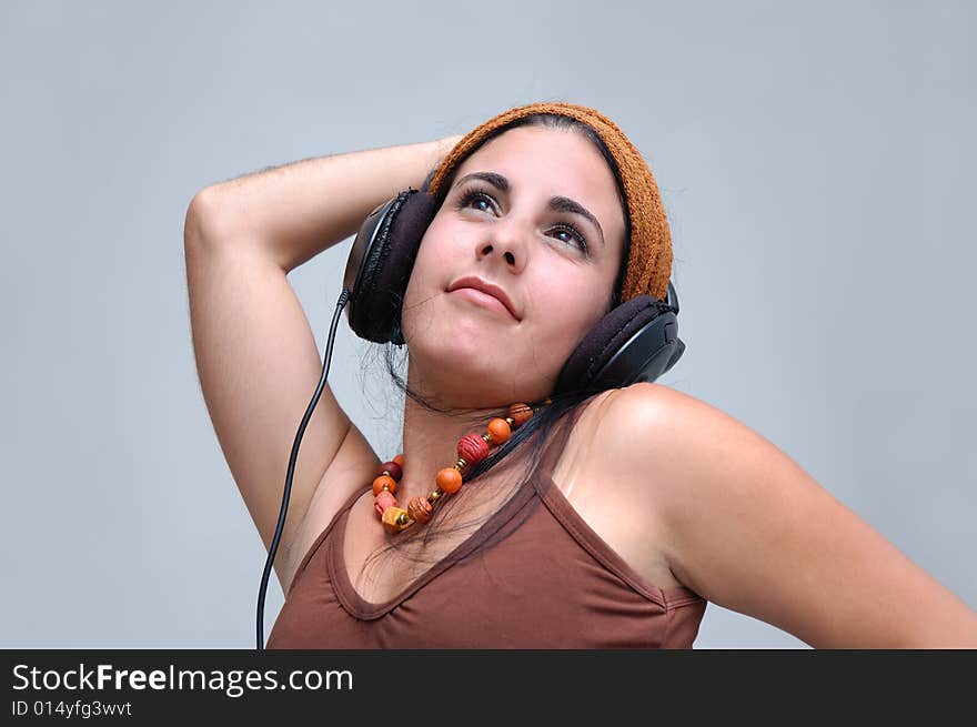 Portrait of young hispanic female listening music with headphones. Portrait of young hispanic female listening music with headphones