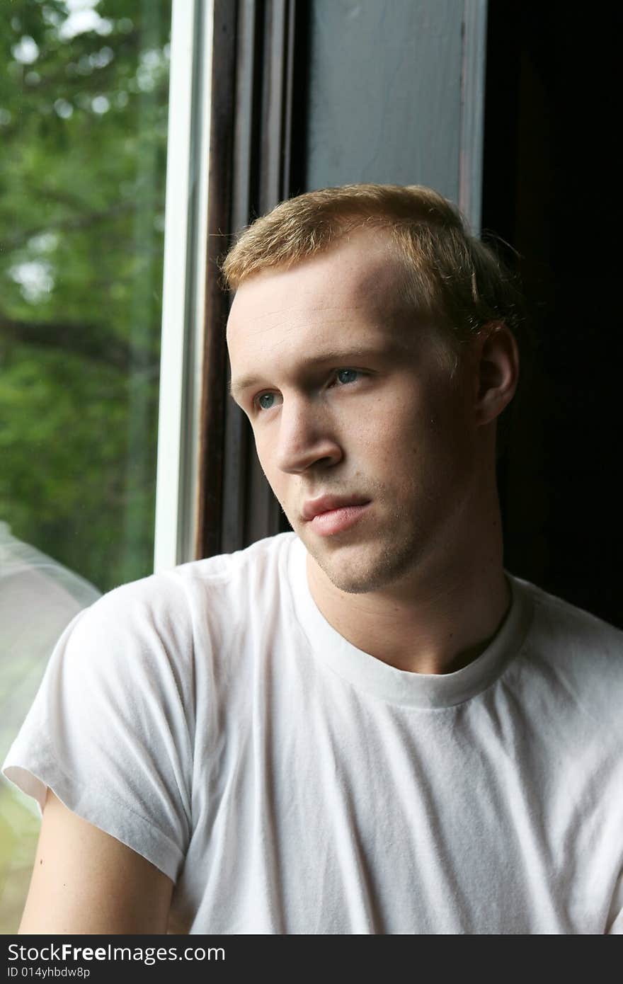 Natural light man with thinning hair at window