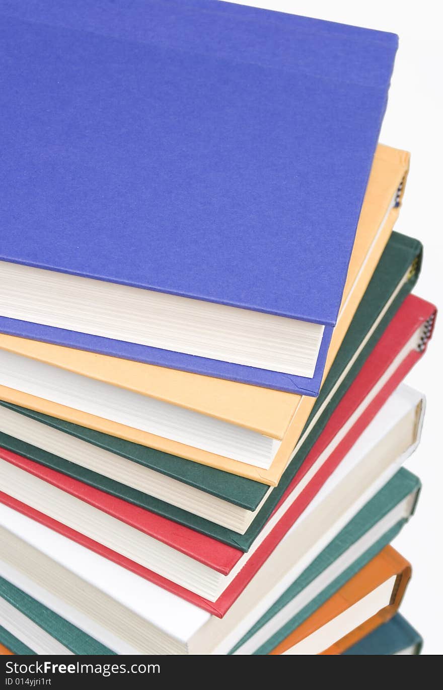 Stacked books on white background