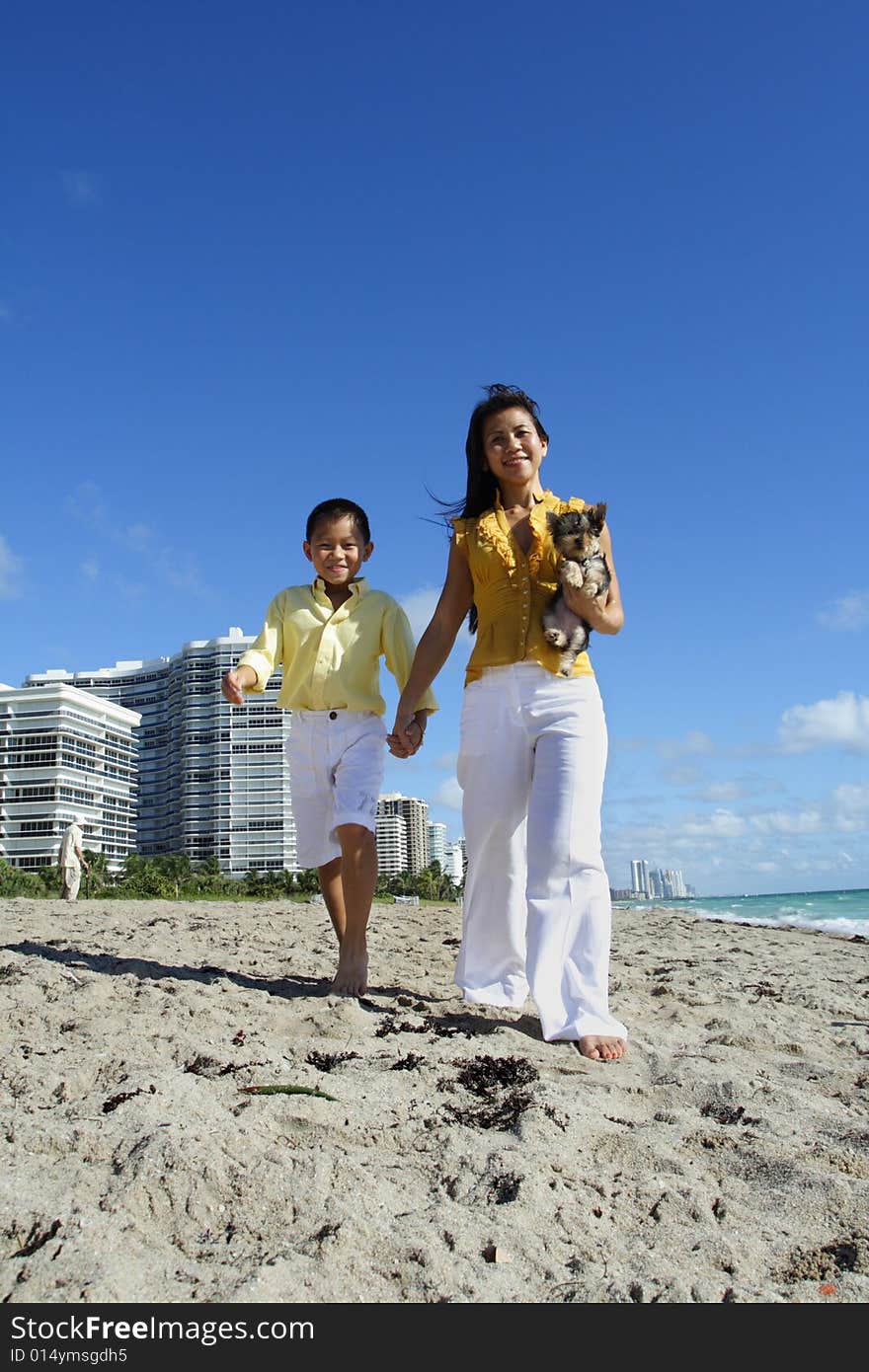 Beautiful young mother walking with her son on the beach. Beautiful young mother walking with her son on the beach.