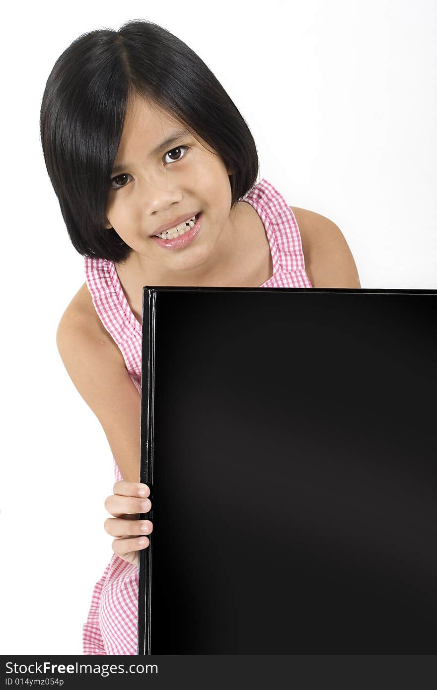 Young pretty Eurasian Chinese girl in pink dress holding up large black rectangle. Young pretty Eurasian Chinese girl in pink dress holding up large black rectangle