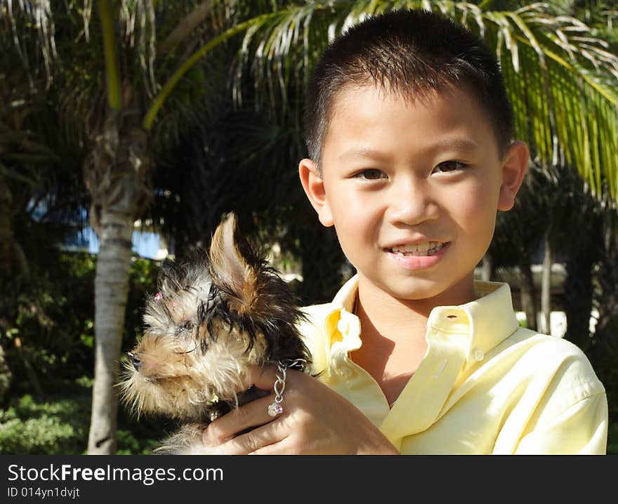 Boy holding his puppy