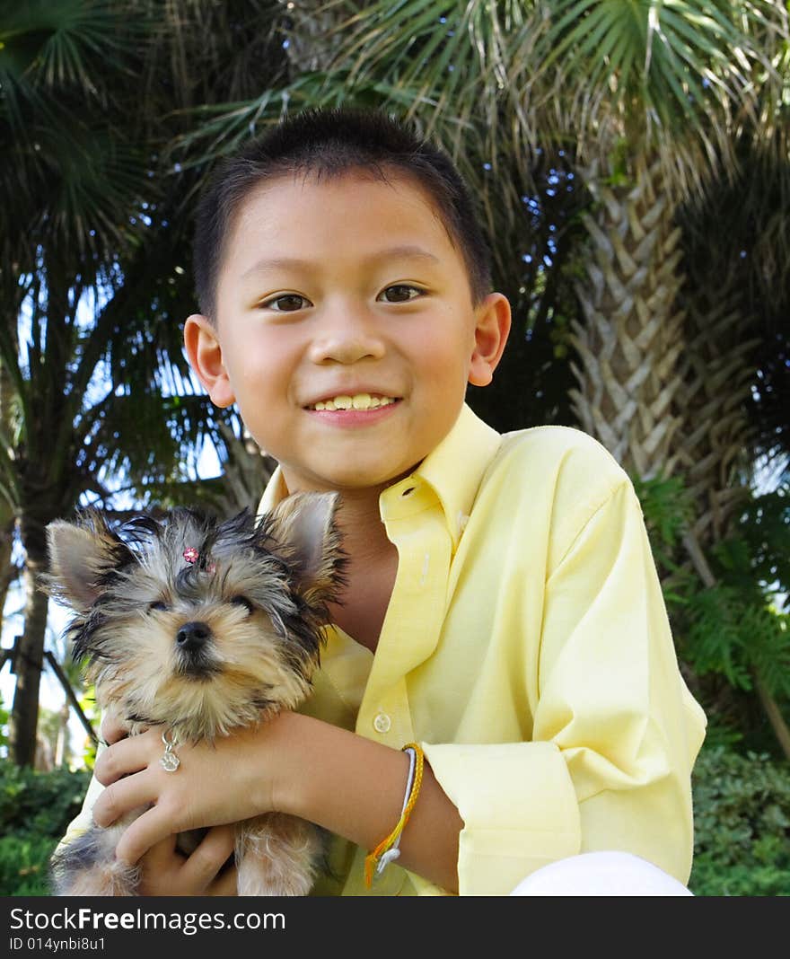 Boy holding his puppy