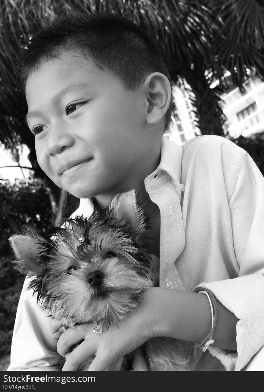 Boy holding his puppy