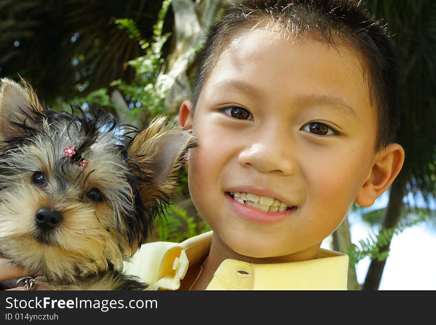 Boy holding his puppy