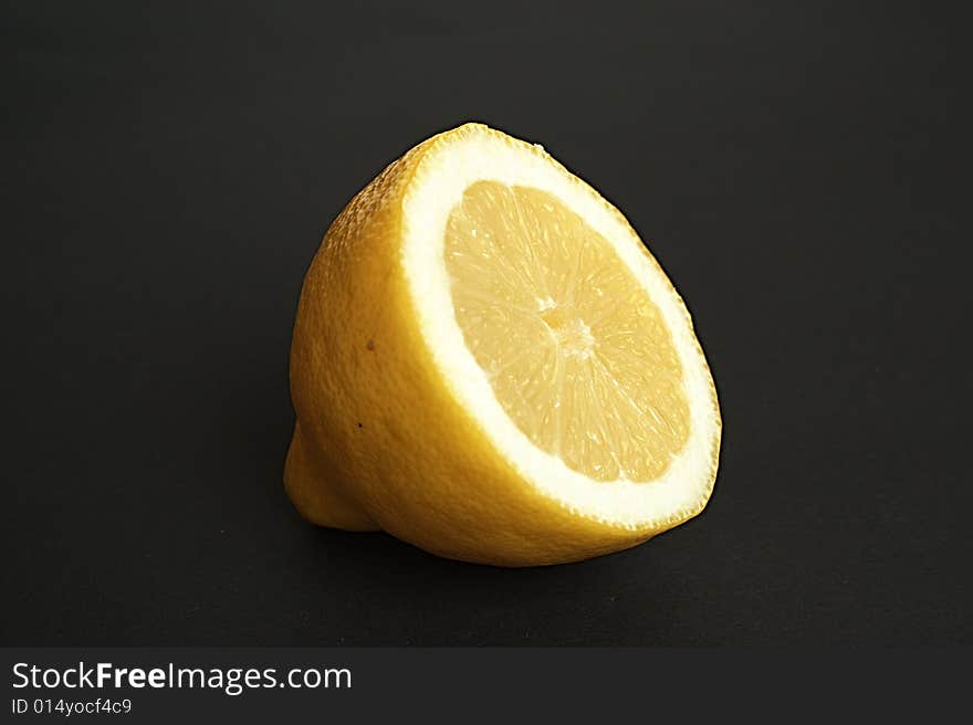 Half of a lemon black background. Half of a lemon black background