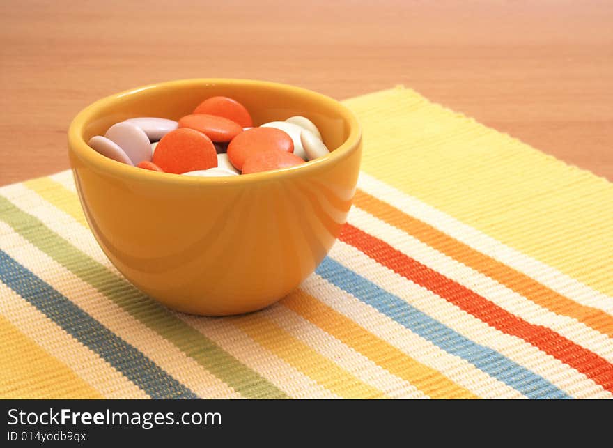 Colorful candy in yellow bowl