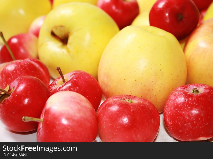 Yellow and red apples against the white background