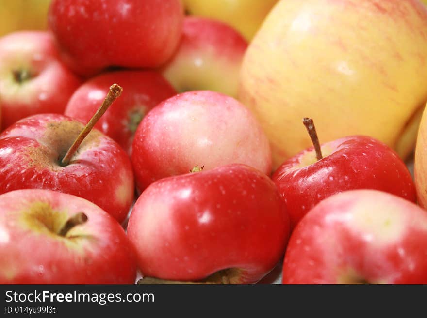 Yellow and red apples against the white background