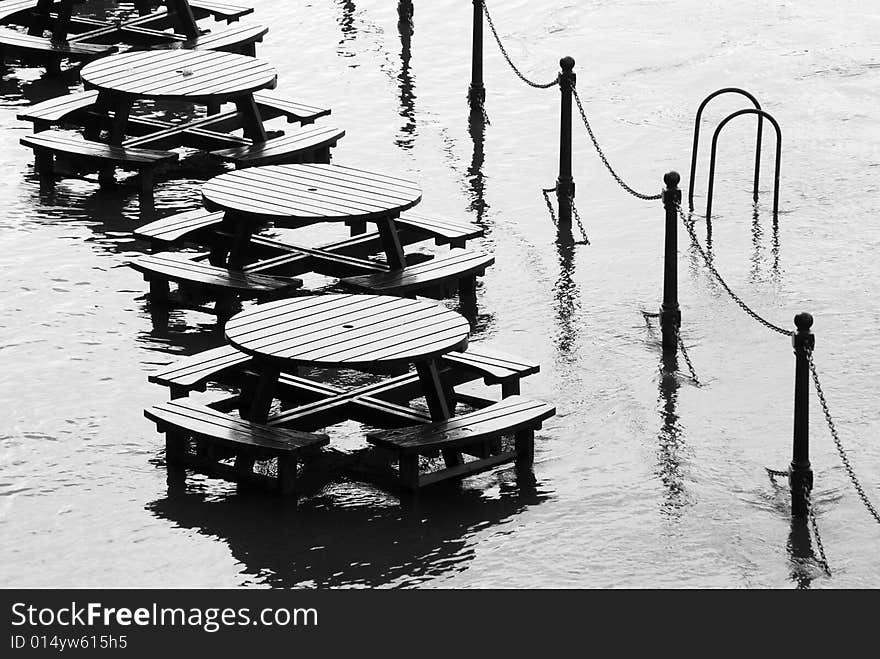 Flooded tables on bank of River Ouse in York. Flooded tables on bank of River Ouse in York.