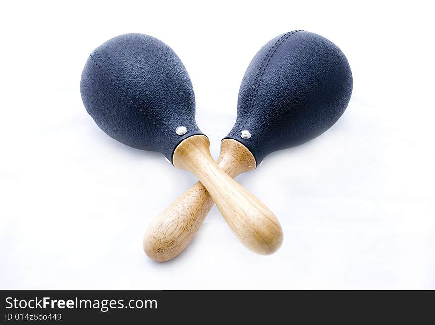 Pair of black plastic maracas isolated on white with wooden handle