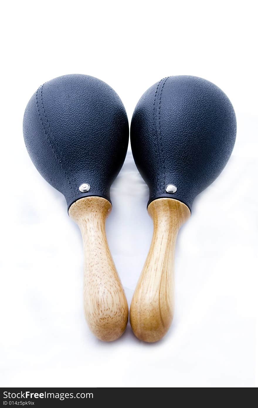 Pair of black plastic maracas isolated on white with wooden handle