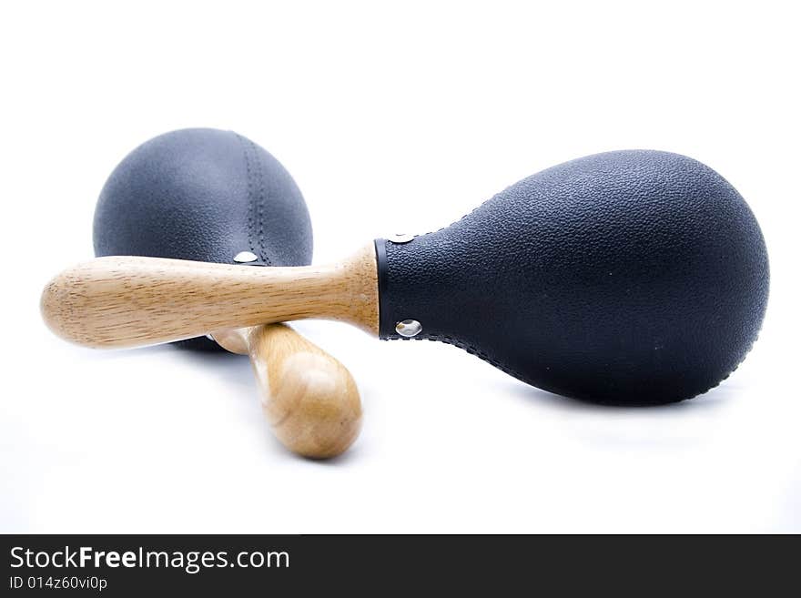 Pair of black plastic maracas isolated on white with wooden handle