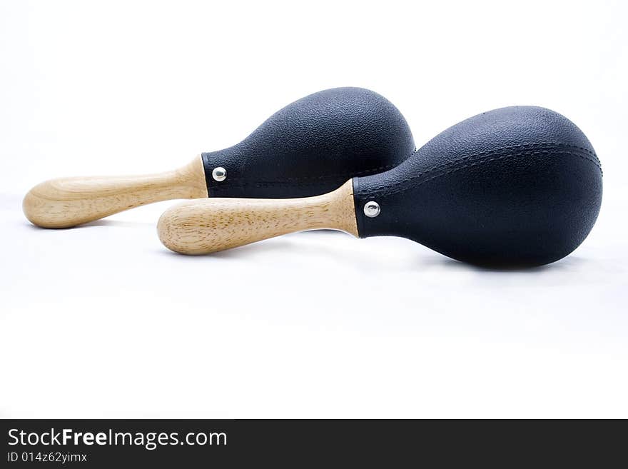 Pair of black plastic maracas isolated on white with wooden handle