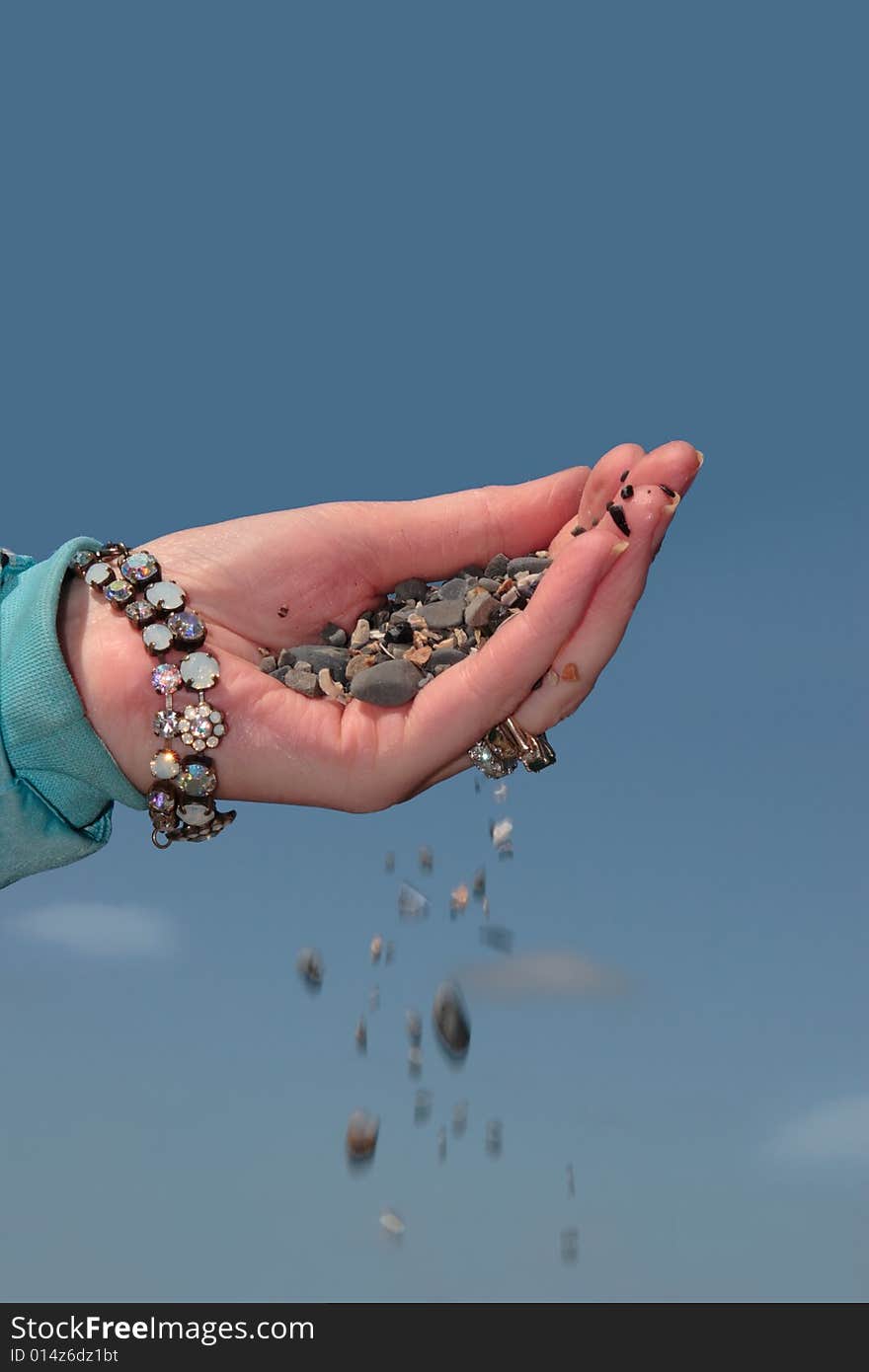 A hand full of earth against a beautiful blue sky. A hand full of earth against a beautiful blue sky