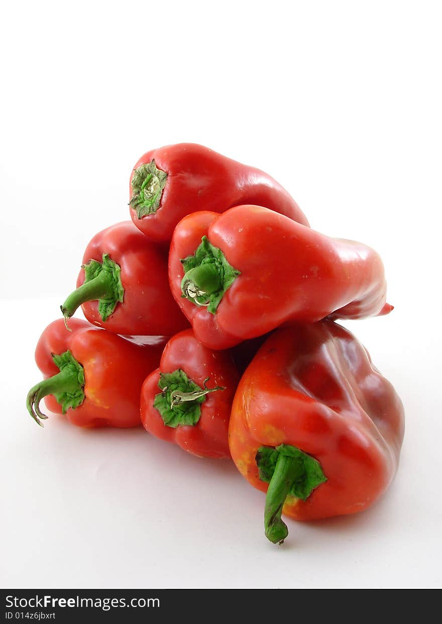 Fresh picked red peppers isolated over white background.