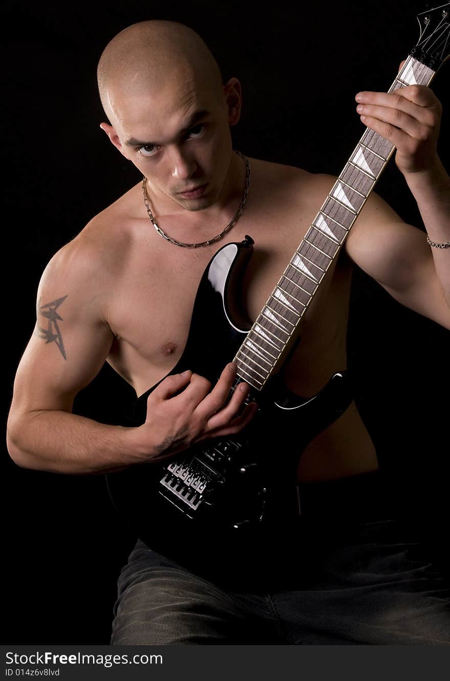 Portrait of the guitarist on a black background