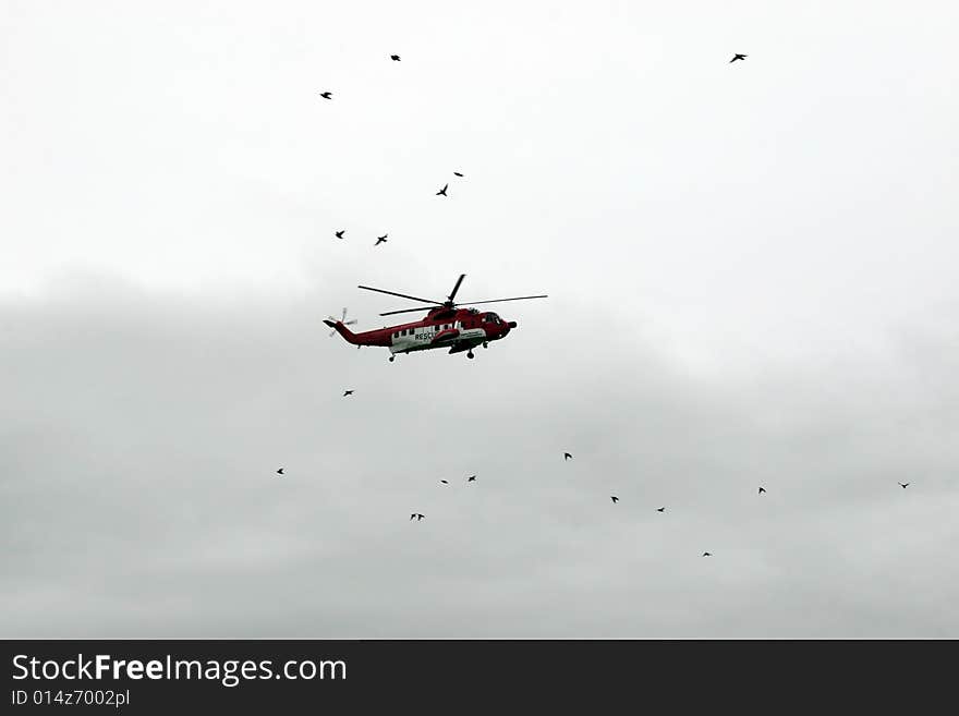 A helicopter on a life air sea rescue mission. A helicopter on a life air sea rescue mission