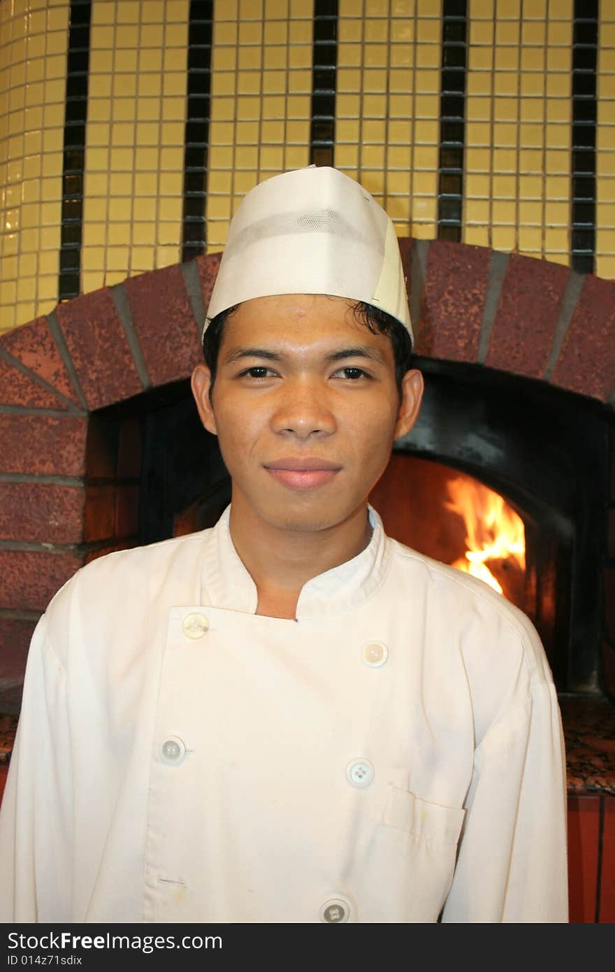 Chef standing at front of pizza oven. Chef standing at front of pizza oven