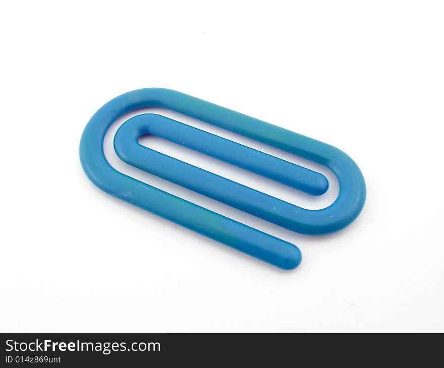 Blue plastic paper clip isolated over white background.