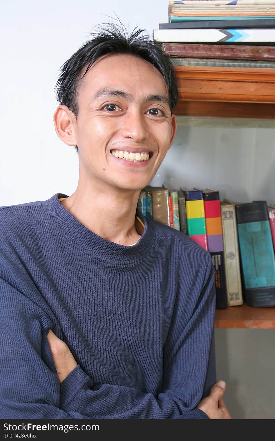 Student standing near by books rack. Student standing near by books rack