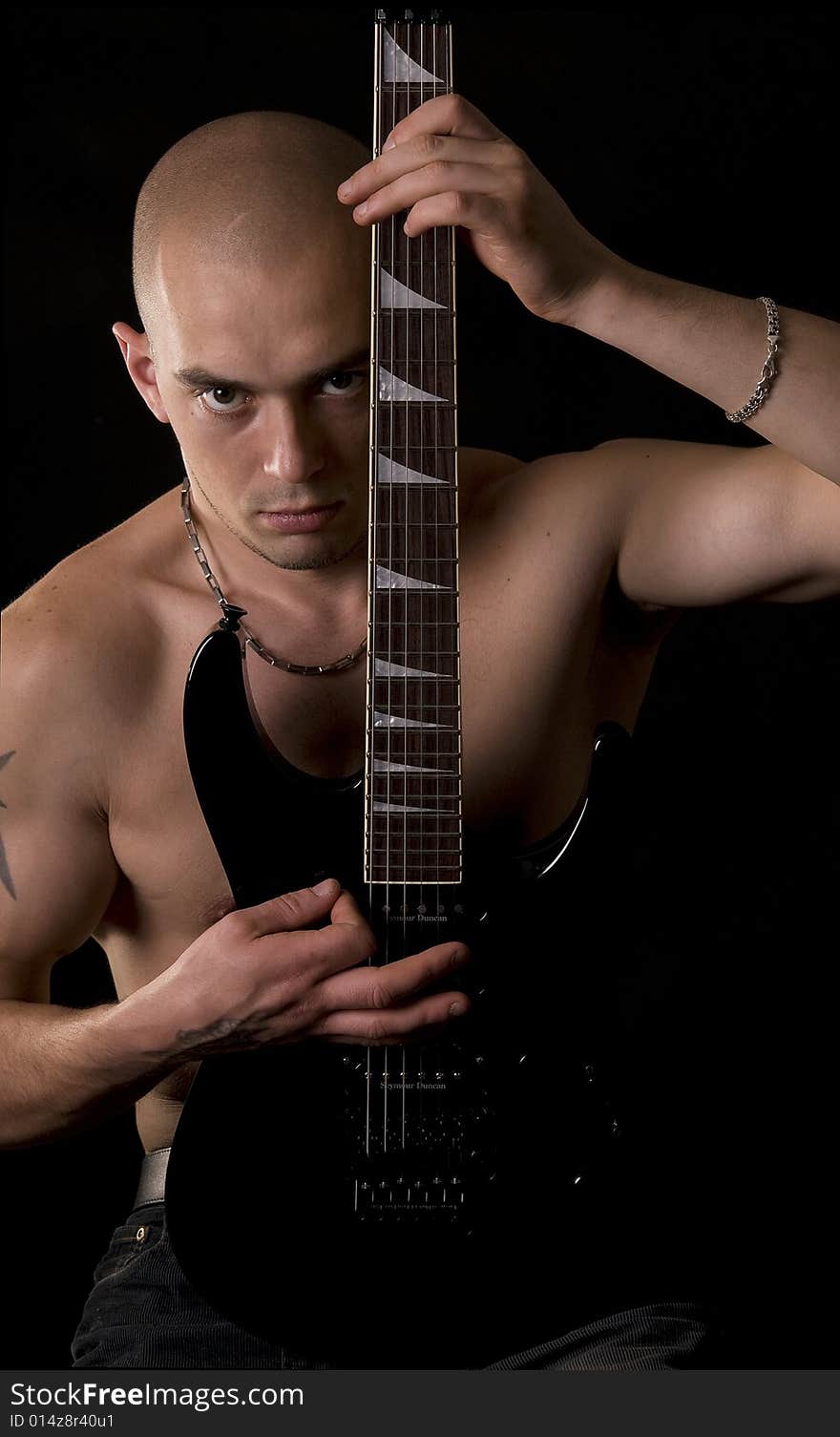 Portrait of the guitarist on a black background