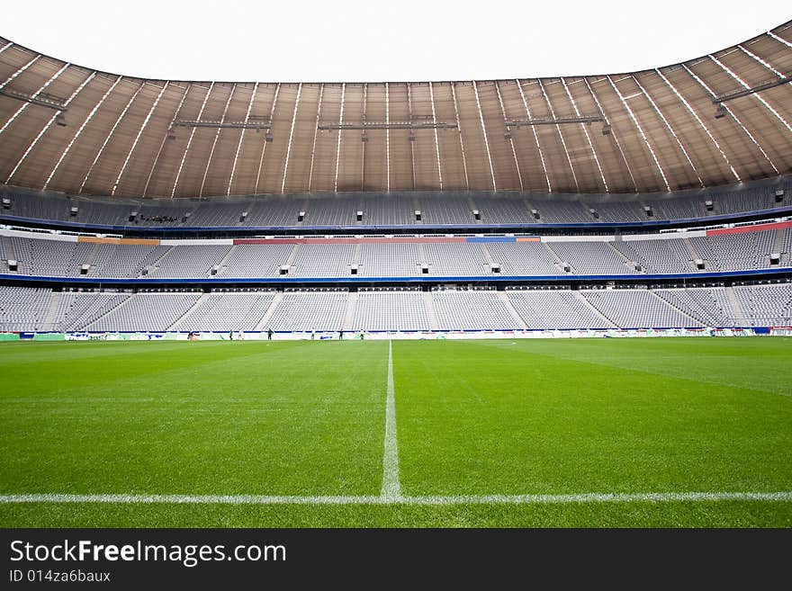 The halfway line on a football pitch in a stadium setting. The halfway line on a football pitch in a stadium setting.