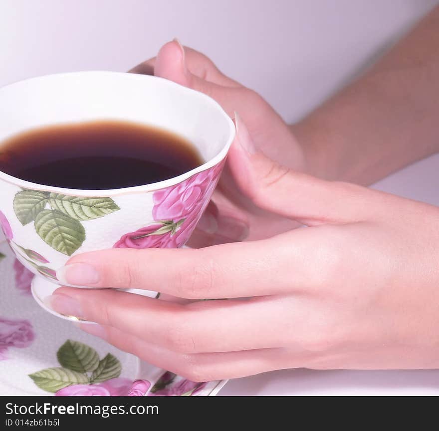 Female hands hold a coffee cup or tea