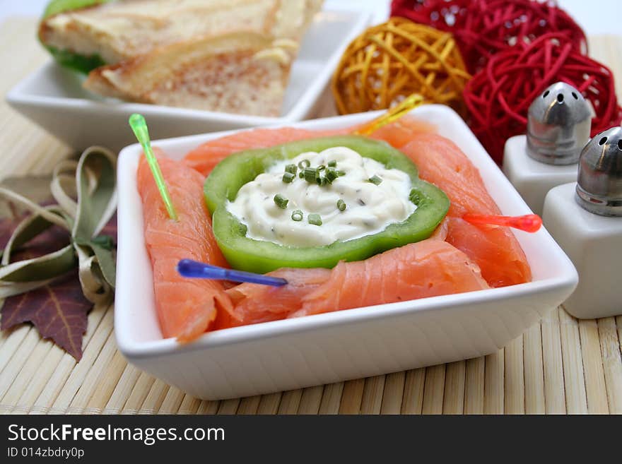 A breakfast of fresh salmon and some bread. A breakfast of fresh salmon and some bread