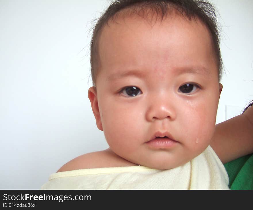 Infant with tears in her mother's arm. Infant with tears in her mother's arm