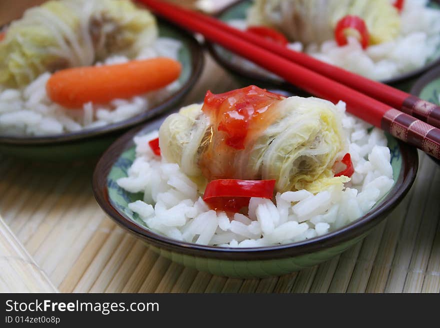 A asian meal of cabbage, meat and some rice. A asian meal of cabbage, meat and some rice