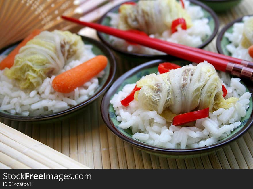 A asian meal of cabbage, meat and some rice. A asian meal of cabbage, meat and some rice