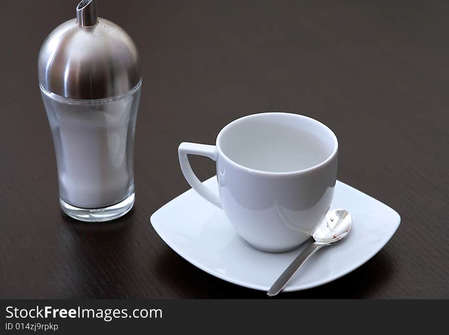 Capucchino cup on a brown table