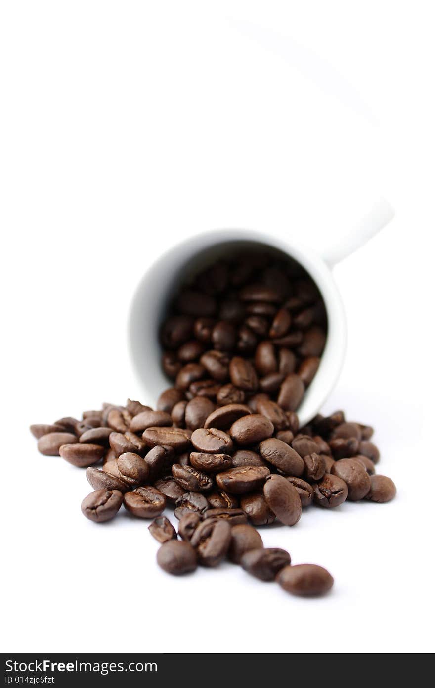 An espresso cup full of coffee beans