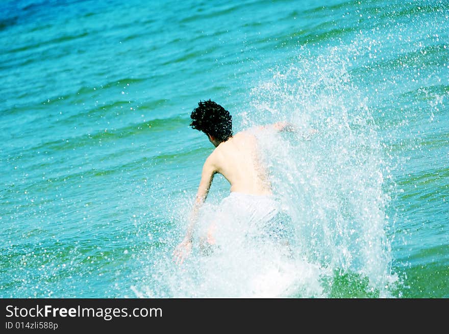 Boy running the the sea. Enjoying summertime