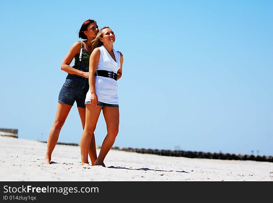 Young attractive girls looking up to the sky. Young attractive girls looking up to the sky