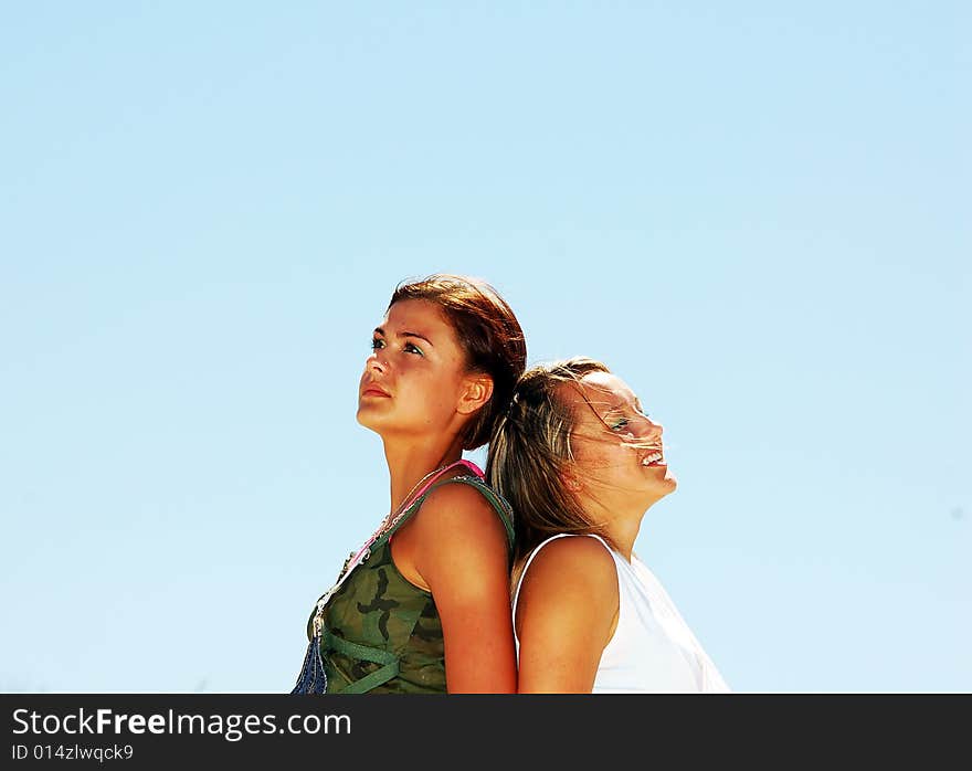 Young attractive girls looking up to the sky. Young attractive girls looking up to the sky