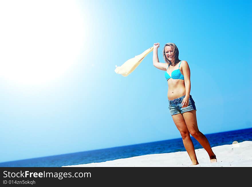 Young attractive woman enjoying summertime on the beach. Young attractive woman enjoying summertime on the beach