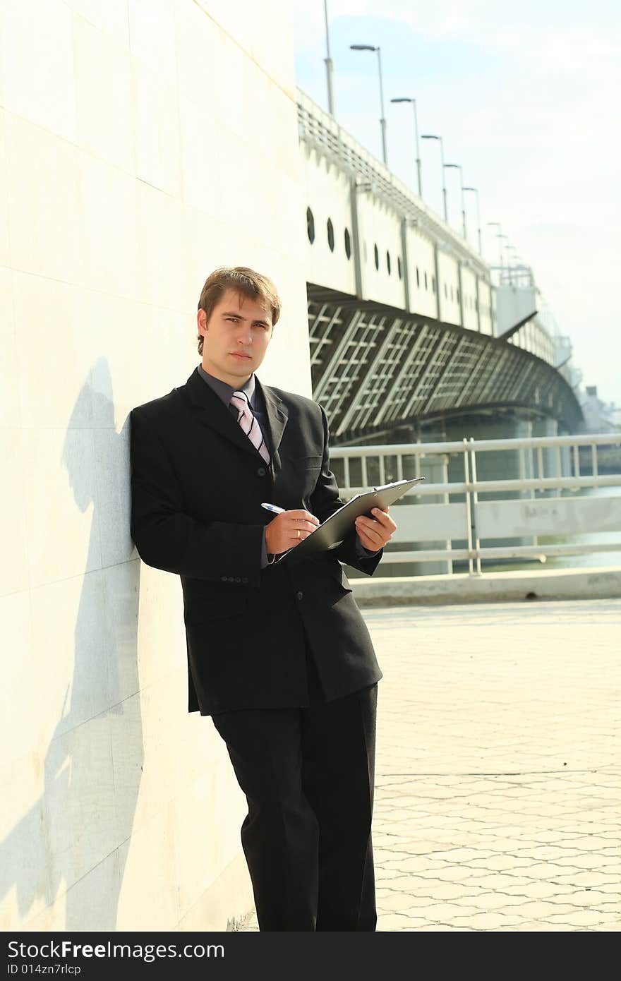 Business background: handsome businessman in a work process. Business background: handsome businessman in a work process.