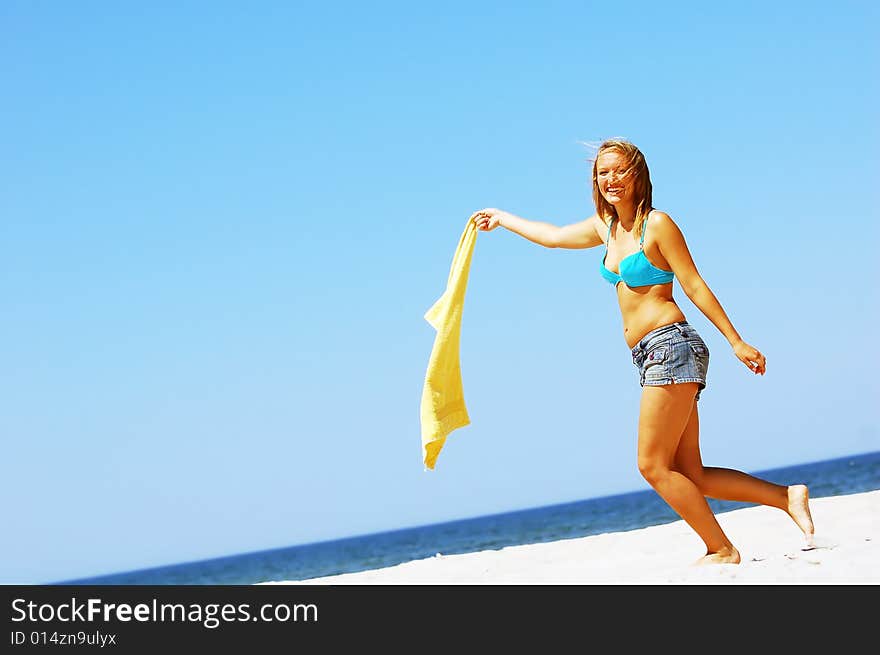 Young attractive woman enjoying summertime on the beach. Young attractive woman enjoying summertime on the beach