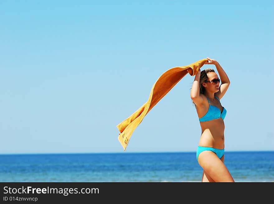 Young attractive woman enjoying summertime on the beach. Young attractive woman enjoying summertime on the beach