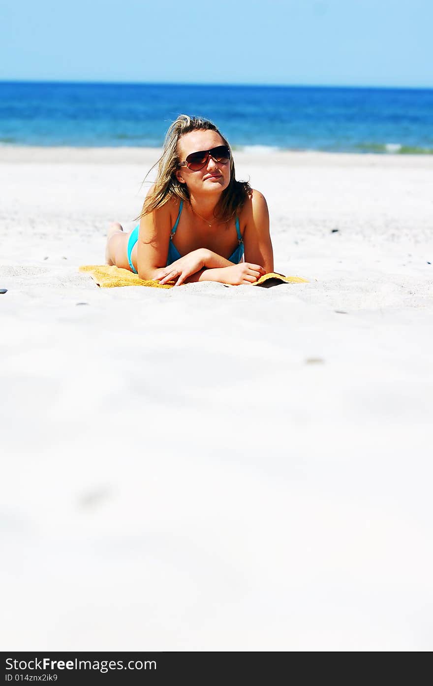 Young attractive woman enjoying summertime on the beach. Young attractive woman enjoying summertime on the beach