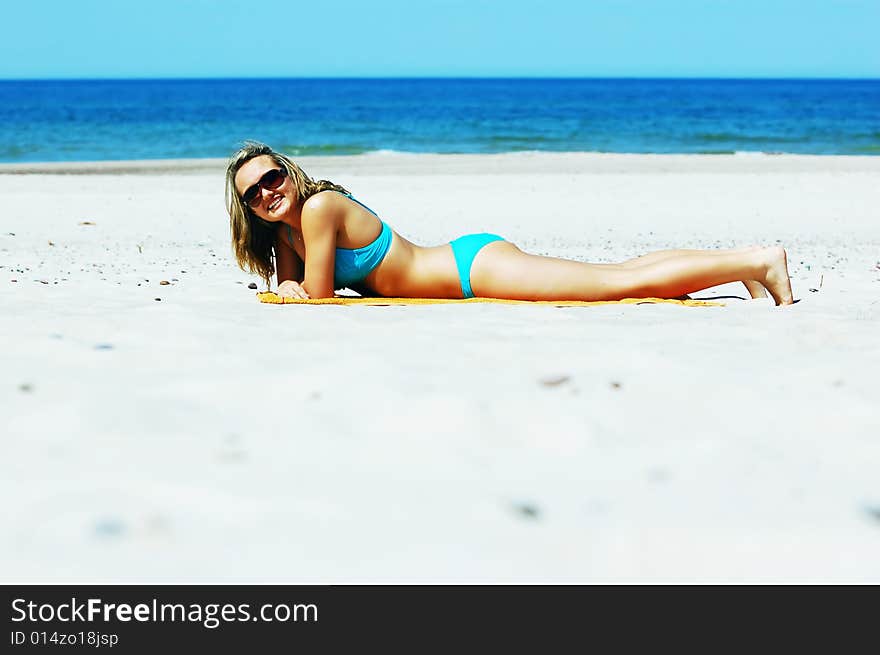 Beautiful woman relaxing on the beach. Lots of useful copyspace. Beautiful woman relaxing on the beach. Lots of useful copyspace