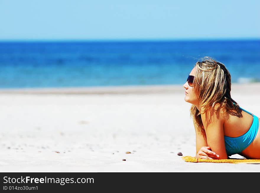 Beautiful woman relaxing on the beach. Lots of useful copyspace. Beautiful woman relaxing on the beach. Lots of useful copyspace