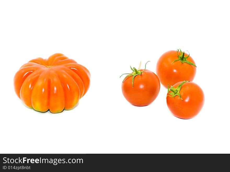 Round small and big red tomatoes on a white background. Round small and big red tomatoes on a white background