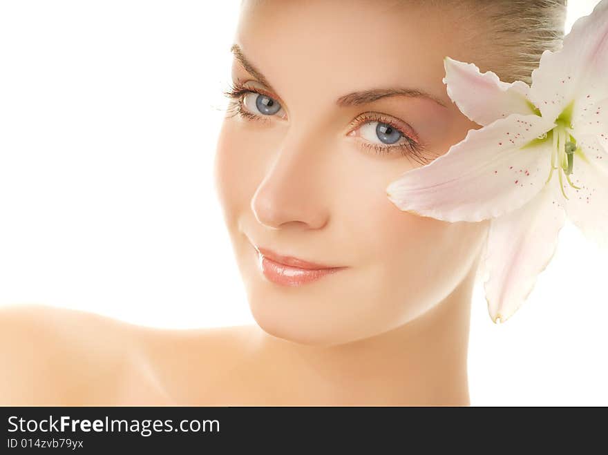 Beautiful young woman with lily flower. Isolated on white background