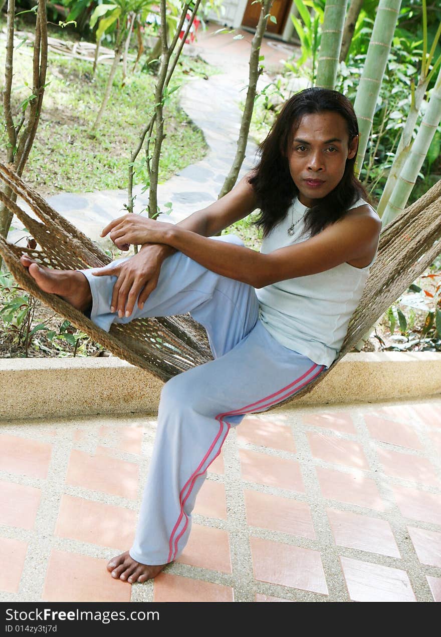 Pportrait of a man from Thailand in a hammock. Pportrait of a man from Thailand in a hammock.