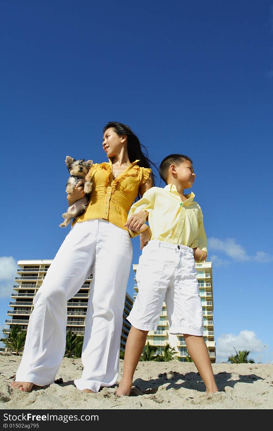 Mother and her son at the beach with blue sky background. Mother and her son at the beach with blue sky background